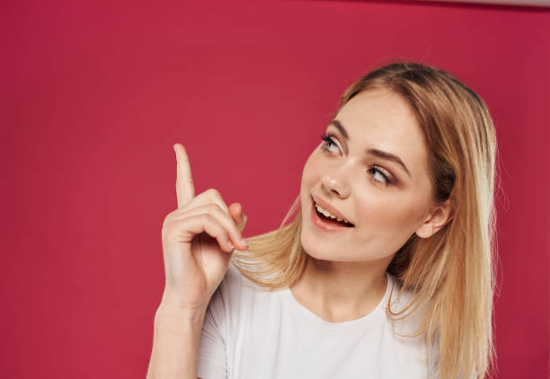 istock Hand gesturing index finger happy blonde red model background 2082933281