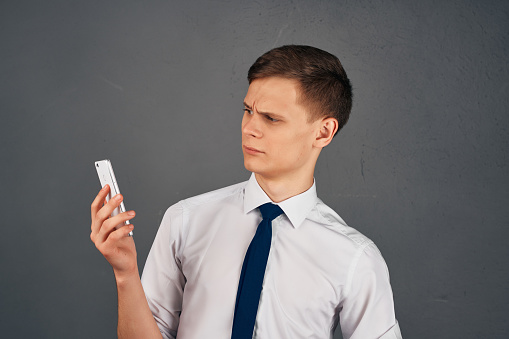 business man in a shirt with a tie with a phone in his hands communication work. High quality photo