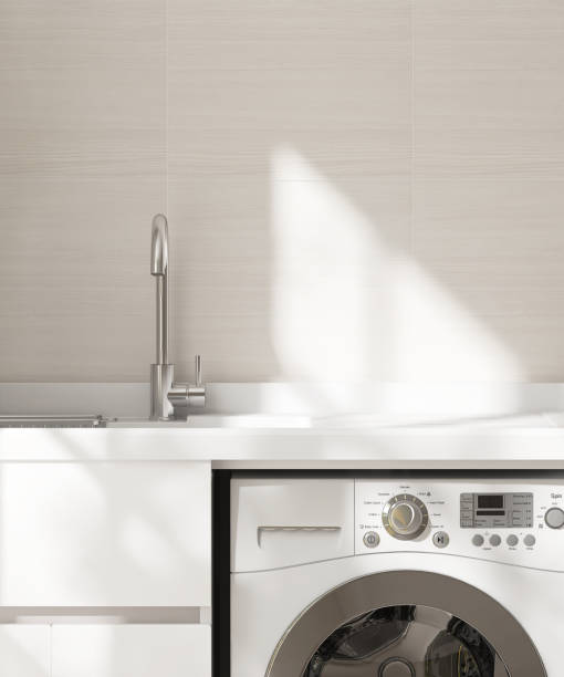istock White kitchen countertop counter with sink and washing machine in sunlight on tiled wall in background 2082937534