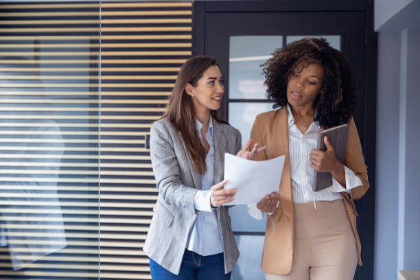 istock Two female colleagues have small talk during break 2082961696