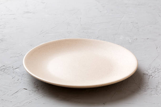 istock Perspective view of empty light plate on cement background. Empty space for your design 2082962798