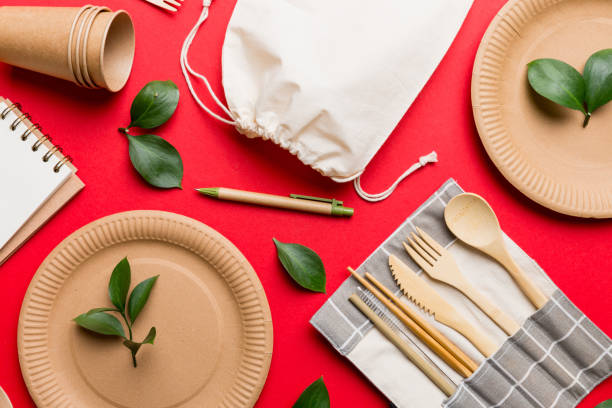 istock set of empty reusable disposable eco-friendly plates, cups, utensils on light white colored table background. top view. Biodegradable craft dishes. Recycling concept. Close-up 2082963283