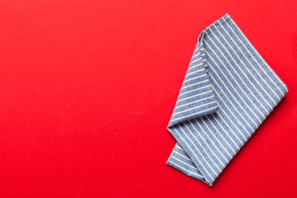 top view with blue kitchen napkin isolated on table background. Folded cloth for mockup with copy space, Flat lay. Minimal style.