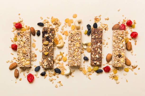 istock Various granola bars on table background. Cereal granola bars. Superfood breakfast bars with oats, nuts and berries, close up. Superfood concept 2082963688