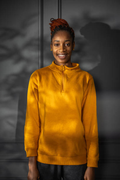 istock Smiling young woman posing on dark gray background 2082981496
