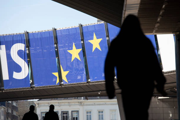 Unrecognisable people walking near the EU Parliament Square