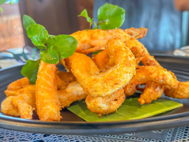 istock Fried salmon sliced on black ceramic plate on the table in restaurant 2082983794