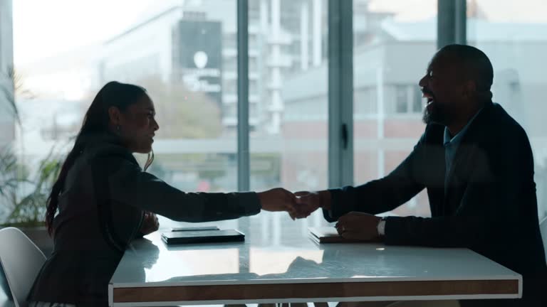 Job interview, handshake and business people in office with silhouette of meeting, collaboration or support for onboarding. Businessman, shaking hands and thank you for hiring, success and welcome