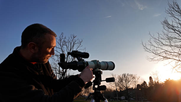 istock Amateur astronomer observing Sun eclipse and Sun with a telescope and special solar filter. 2083010665