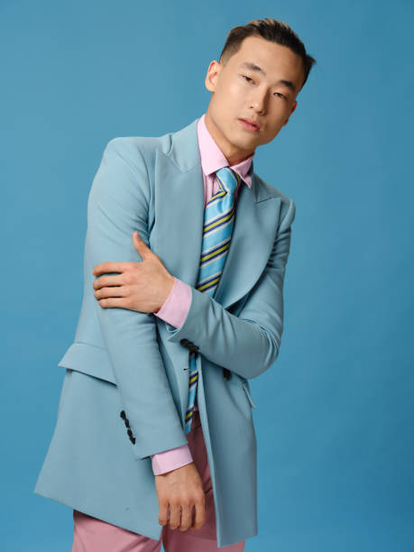 istock A man in a jacket and a pink shirt on a blue background pants cropped view 2083017431