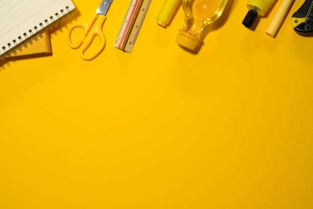 istock Various office and school supplies on yellow background. Flat lay, top view with copy space 2083038887