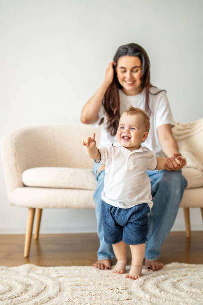istock Woman Sitting on Couch With Baby 2083040583