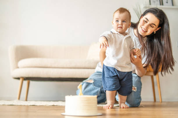 istock Woman and baby playing with cake 2083040625