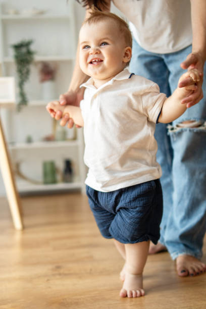 istock Man and baby walking on hardwood floor 2083041010