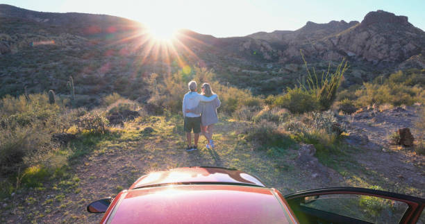 istock Mature couple park car in desert 2083044325