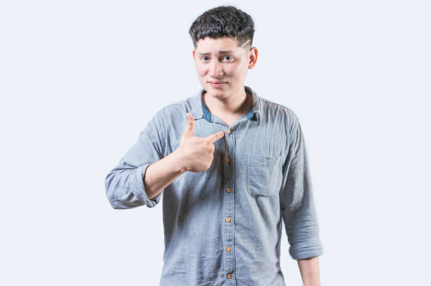 istock Embarrassed young man pointing at himself isolated. Confused man pointing at himself isolated 2083050719