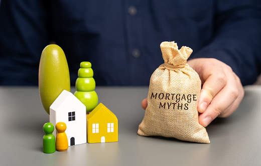 Mortgage myths concept. Misconceptions or misunderstandings about mortgages that can mislead borrowers. Real estate and loan concept. Money bag and miniature houses with family figures