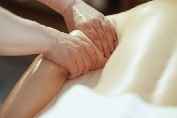 istock Massage therapist in massage cabinet massaging clients arm 2083084604