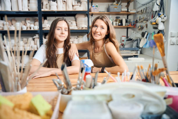 istock Females ceramist sitting at table in pottery workshop 2083086744