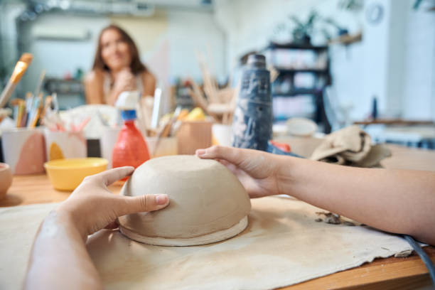 istock Unrecognizable woman sculpting clay bowl in workshop 2083086784