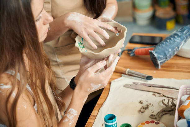 istock Potter women enjoying craft creative making handmade clay products 2083087331