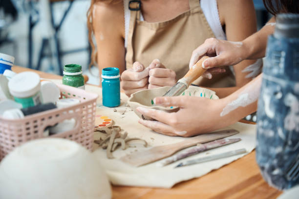 istock Unrecognizable women artisans handcrafting carving pottery with tools 2083087338