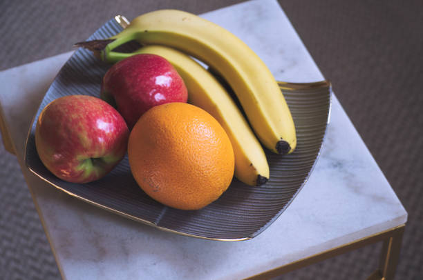 Bananas and oranges on a plate.
