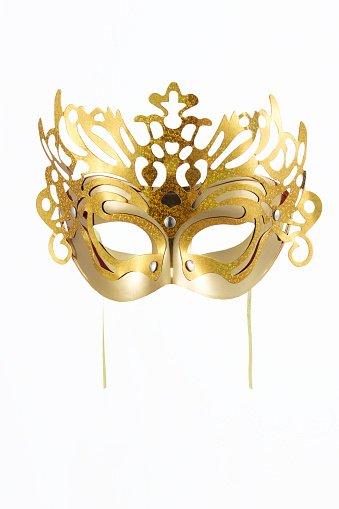 Close up of black and white carnival mask with golden bells at City of Venice on a cloudy summer day. Photo taken August 6th, 2023, Venice, Italy.