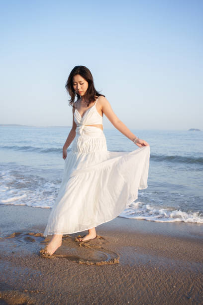 istock Asian female tourist at the beach 2083139521