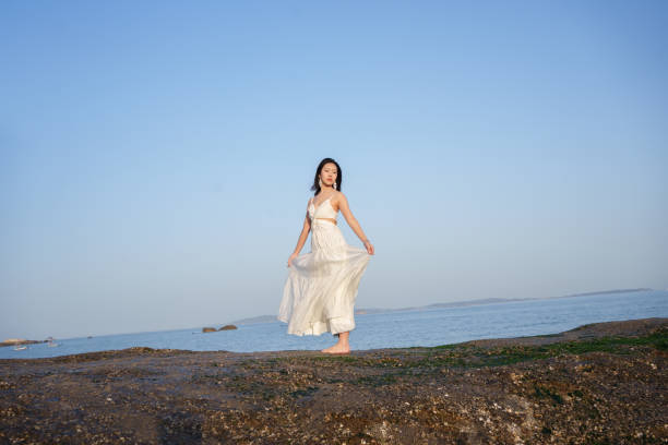 Tourists wearing white dresses at the beach