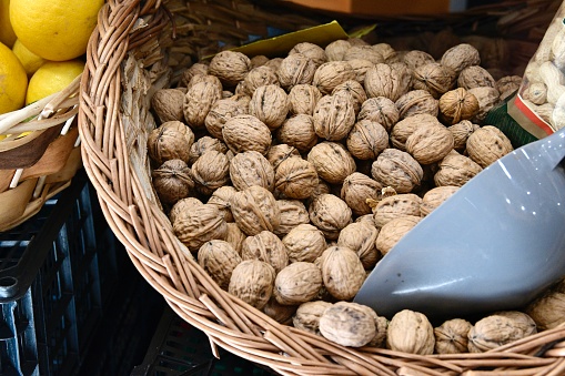 Loose dried walnuts in a wicker basket