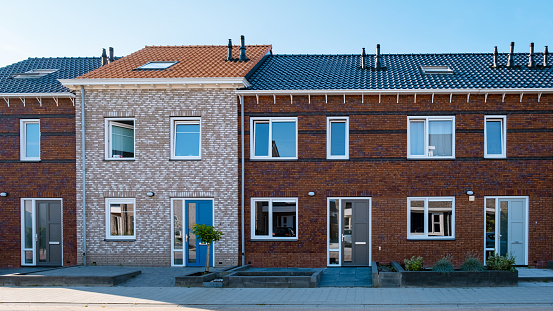 Dutch Suburban area with modern family houses, newly build modern family homes in the Netherlands, dutch family houses in the Netherlands, newly build streets with modern houses.