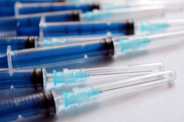 istock Many blue medical syringes on a white background. 2083183662