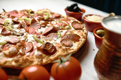 A delicious pizza topped with a variety of toppings, resting on a table.