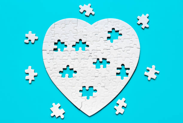 istock Jigsaw Puzzle Pieces Arranged into a White Heart Shape on Blue 2083195260