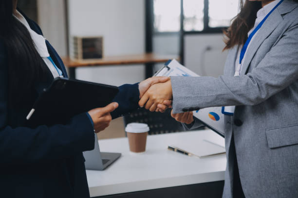 istock Real estate broker agent and customer shaking hands after signing contract documents for realty purchase, Bank employees congratulate, Concept mortgage loan approval. 2083224246