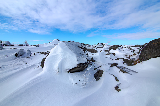 A snow-covered winter mountain crag.