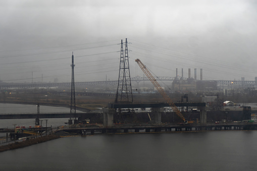 View over the Hudson river from the New Jersey turnpike.  This is on a very wet and dark spring day with mist over the industrial area on the river.