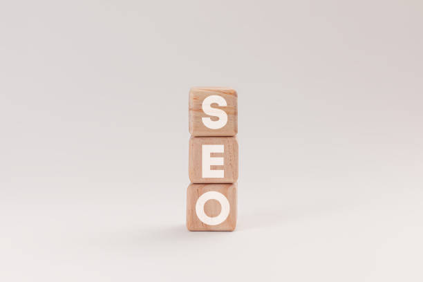 istock Wooden blocks with letters spelling SEO, representing Search Engine Optimization, isolated on a white background. The blocks highlighting the concept of online marketing and website ranking strategies. 2083244462