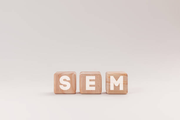 istock Wooden blocks with letters spelling SEM, representing Search Engine Marketing, isolated on a white background. The blocks highlighting the concept of online marketing and website ranking strategies. 2083246437