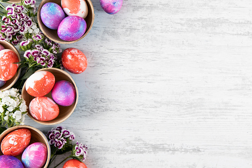 Colorful Easter eggs on white rustic background