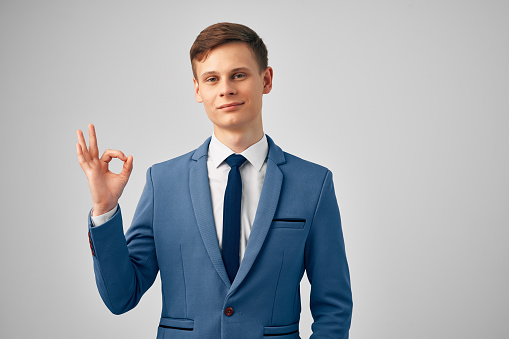 cheerful business man in suit gesturing with hand emotions posing studio. High quality photo