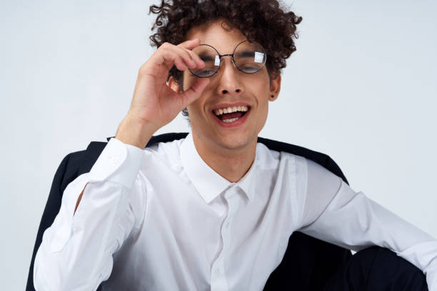 istock guy curly hair glasses and jacket photography studio model light background Copy Space 2083290715