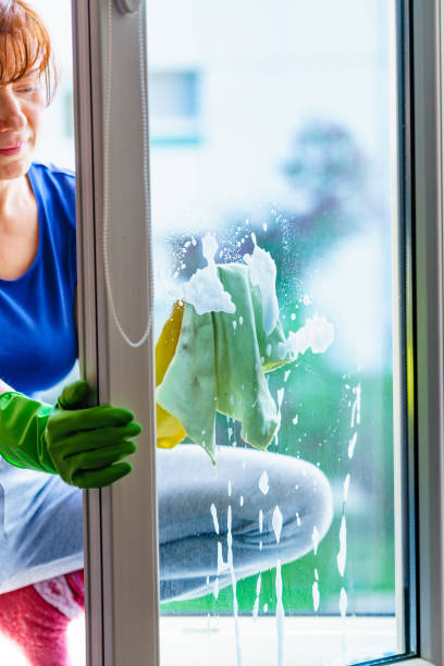 istock Woman cleaning window at home 2083299862