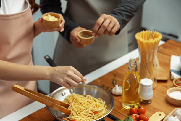 istock Close up hand couple influencers cooking spaghetti mix ingredient. Postulate. 2083311659