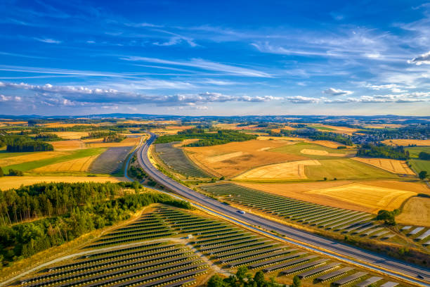 istock solar farm near the highway road interchange (aerial) 2083320670