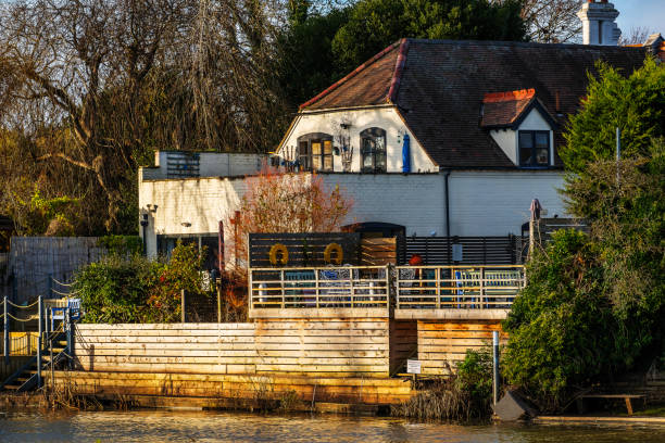 March 14th, 2024 A View of bidford on avon buildings alongside the river avon warwickshire england uk. A sunny day and there are no visible people in the picture.