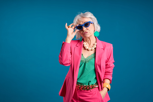 Fashionable Senior Woman with Sunglasses and a Smartphone