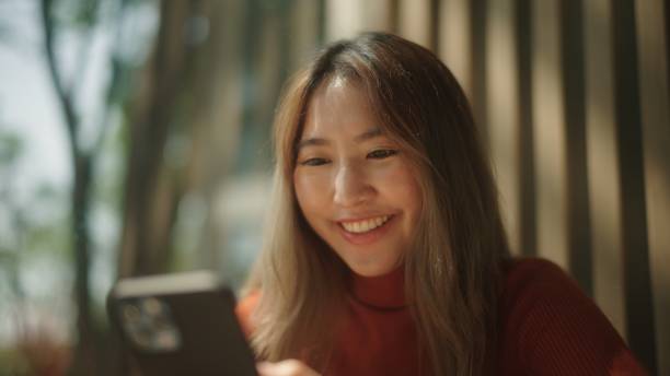 istock Happy woman using smartphone. 2083329055