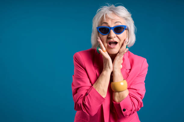 istock Stylish Senior Lady in Shock with Hands on Cheeks 2083329567
